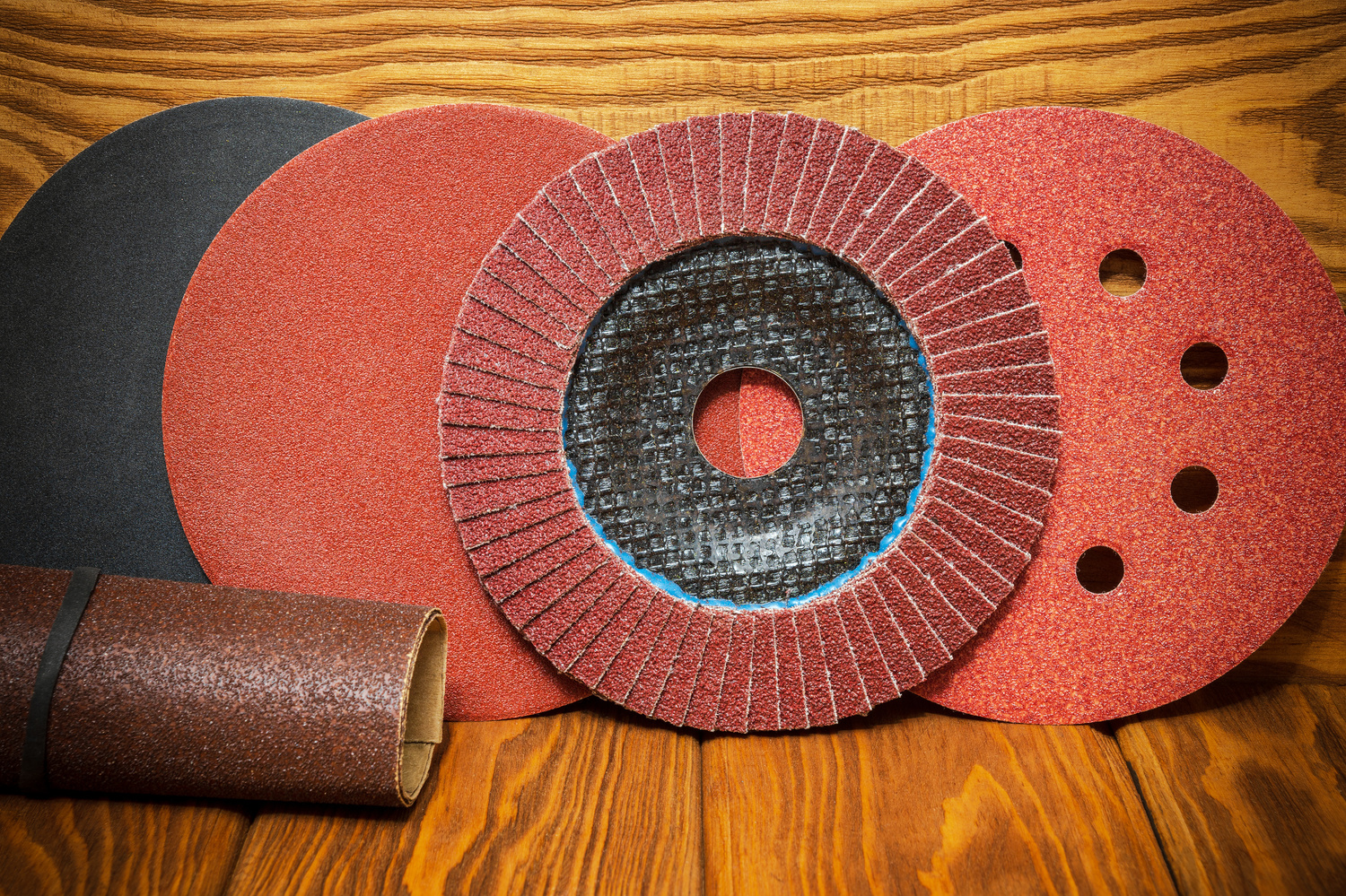 Set of abrasive tools and sandpaper on vintage wooden background